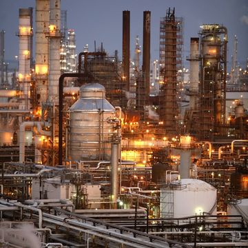 An oil refinery lit up at dusk